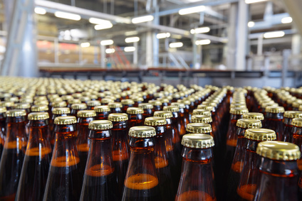 Beer bottles moving through a production facility.