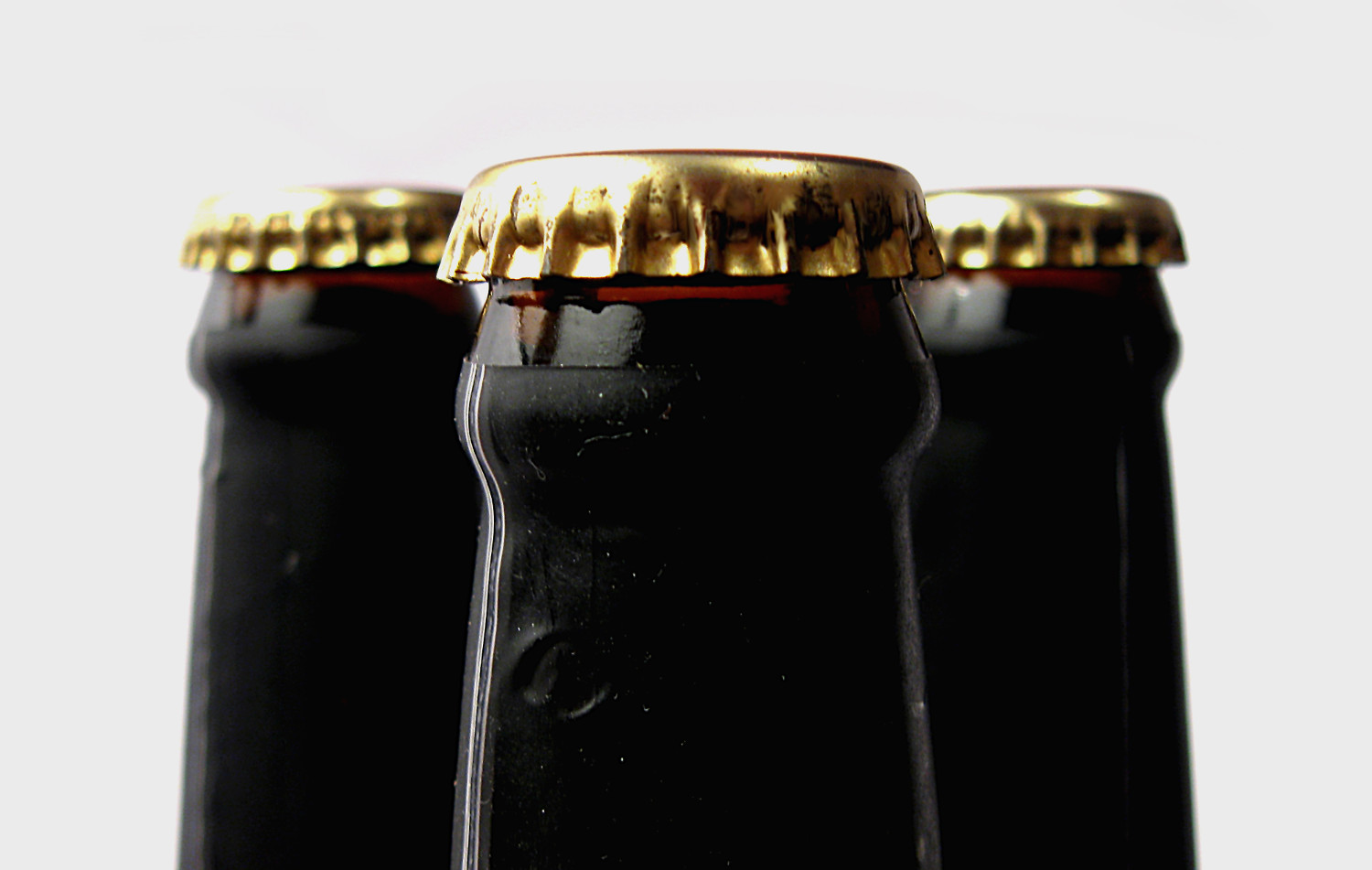 Close-up of capped beer bottles for sensory difference testing.
